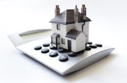 House on calculator concept for mortgage calculator, home finance or saving for a house loan